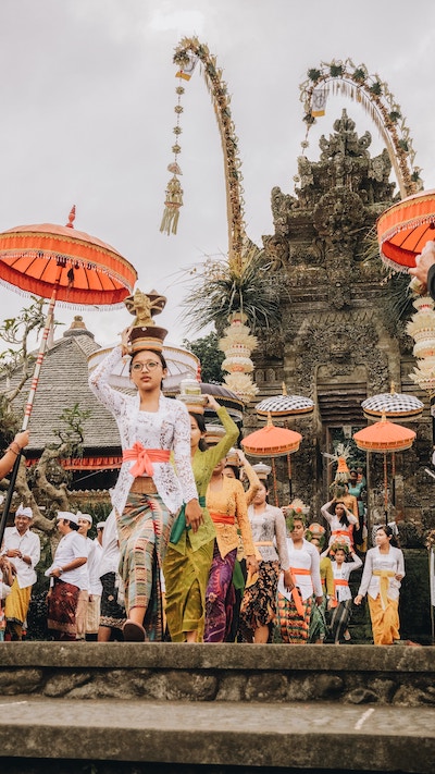 women wearing religious head-wear, leaving temple in Bali during a ceremony