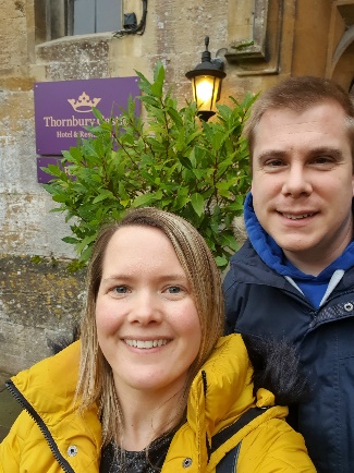 Couple standing outside the entrance to Thornbury Castle after winning a Weekender prize in one of our Weekly Draws