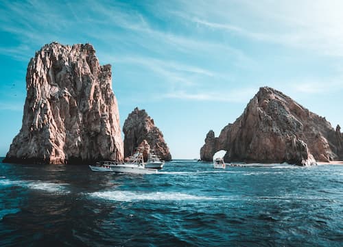 Jagged cliffs in blue waters off the coast of Mexico