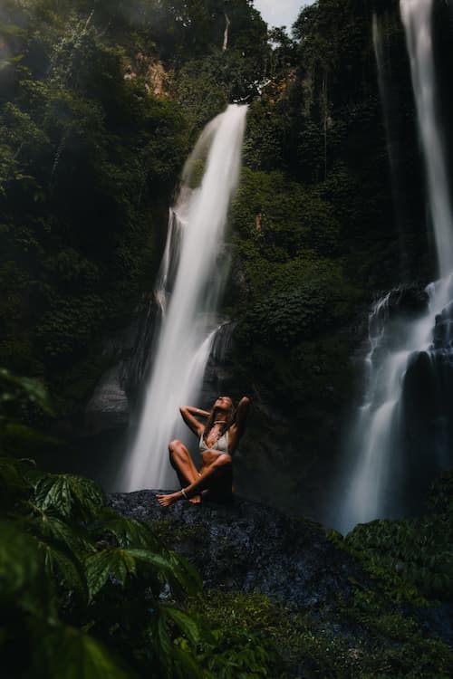 Woman relaxing in jungle waterfall in the Philippines