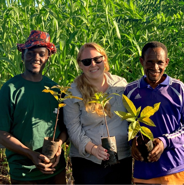 tree planting charity workers holding plants