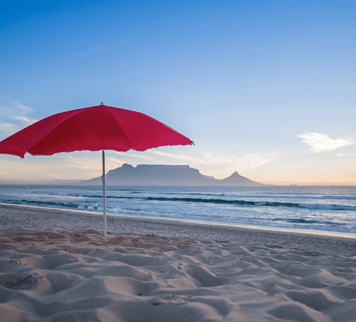 red sun-umbrella on white sand beach